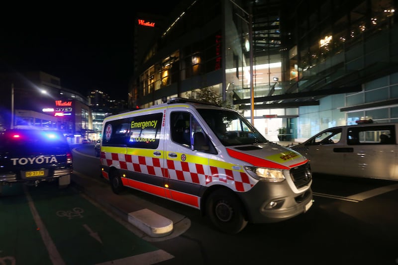 BONDI JUNCTION, AUSTRALIA - APRIL 13: A NSW ambulance moves along Oxford Street outside Westfield Bondi Junction on April 13, 2024 in Bondi Junction, Australia. Six victims, plus the offender, are confirmed dead following an incident at Westfield Shopping Centre in Bondi Junction, Sydney. (Photo by Lisa Maree Williams/Getty Images)